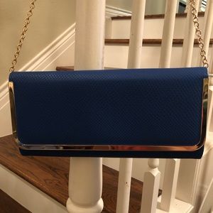 Also clutch purse with gold chain